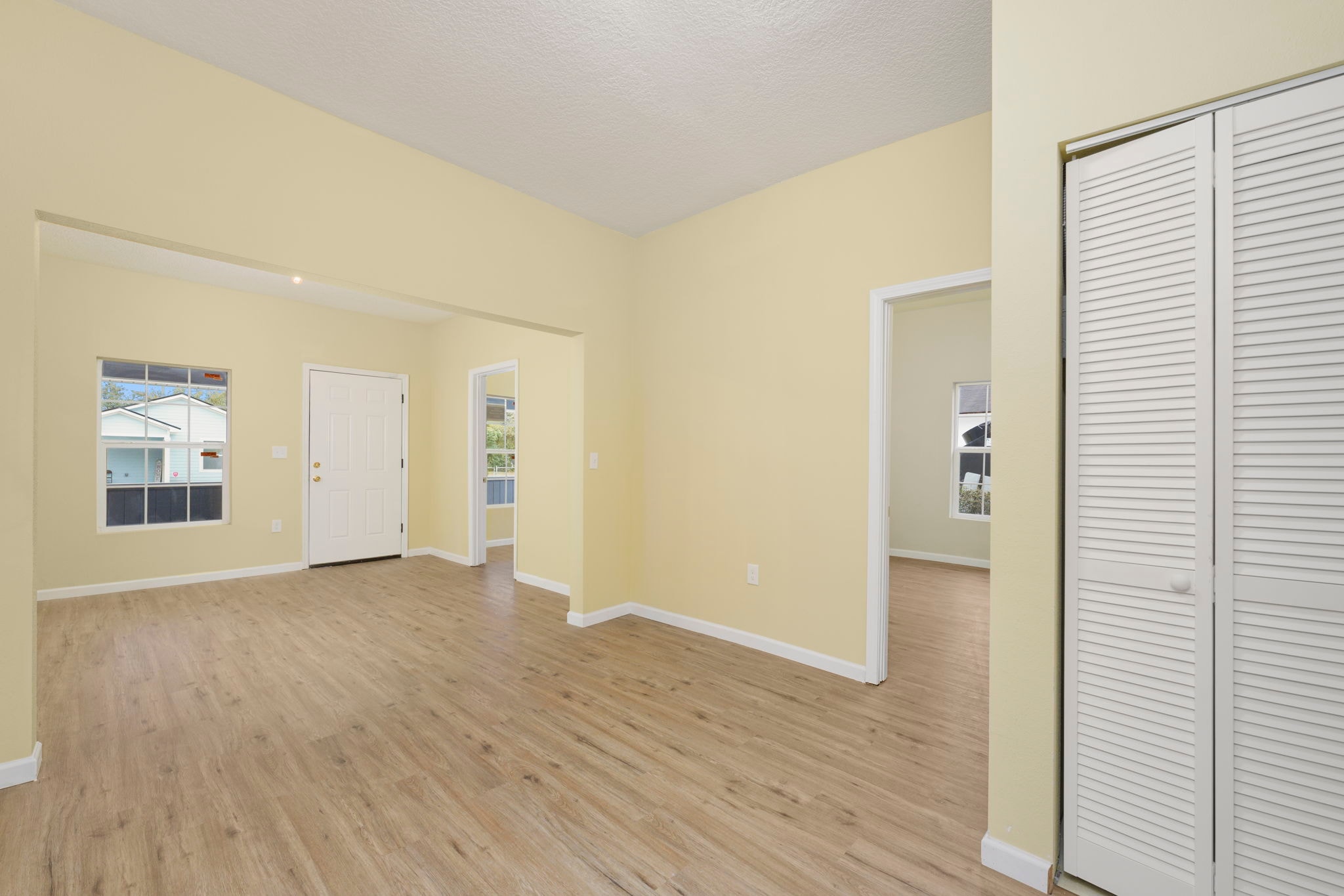Open living space with closet and multiple rooms visible