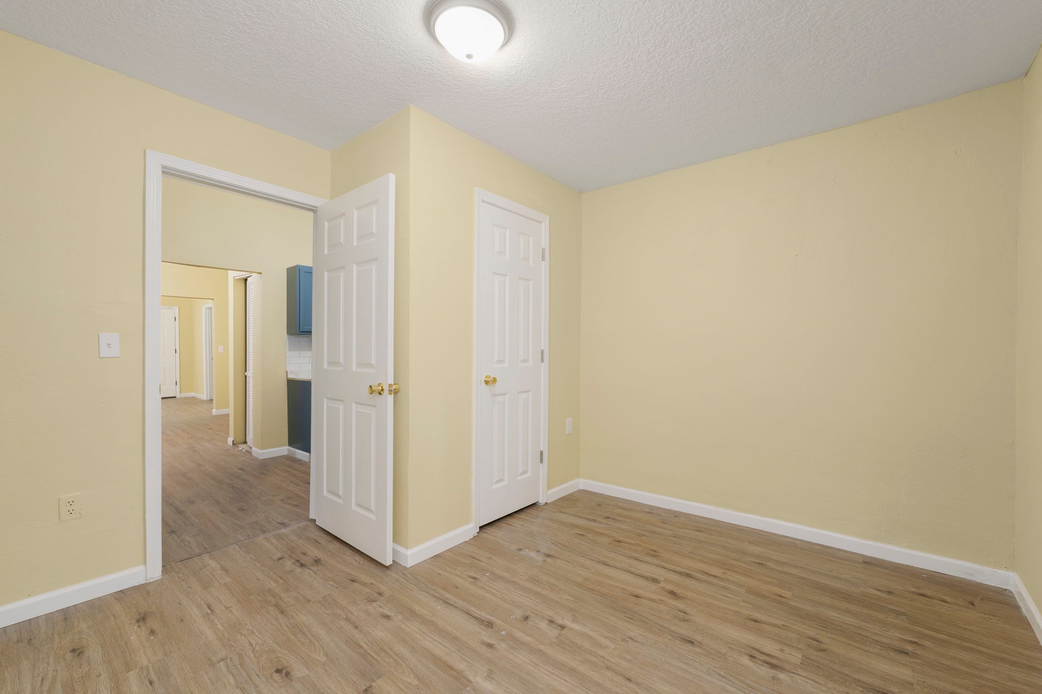 Bright room with yellow walls, white trim and wood flooring