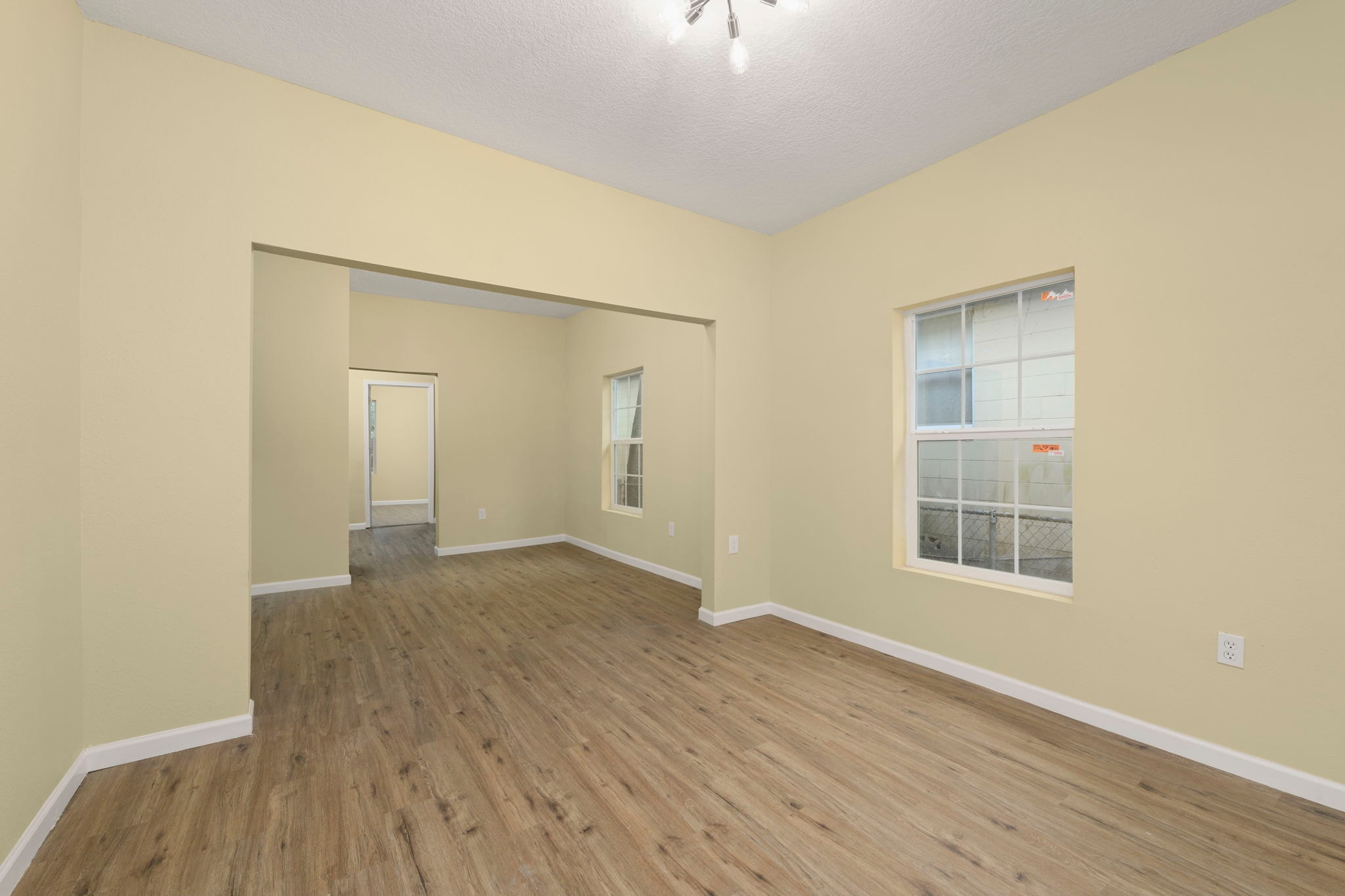 Bright living room with pale yellow walls and new wood flooring