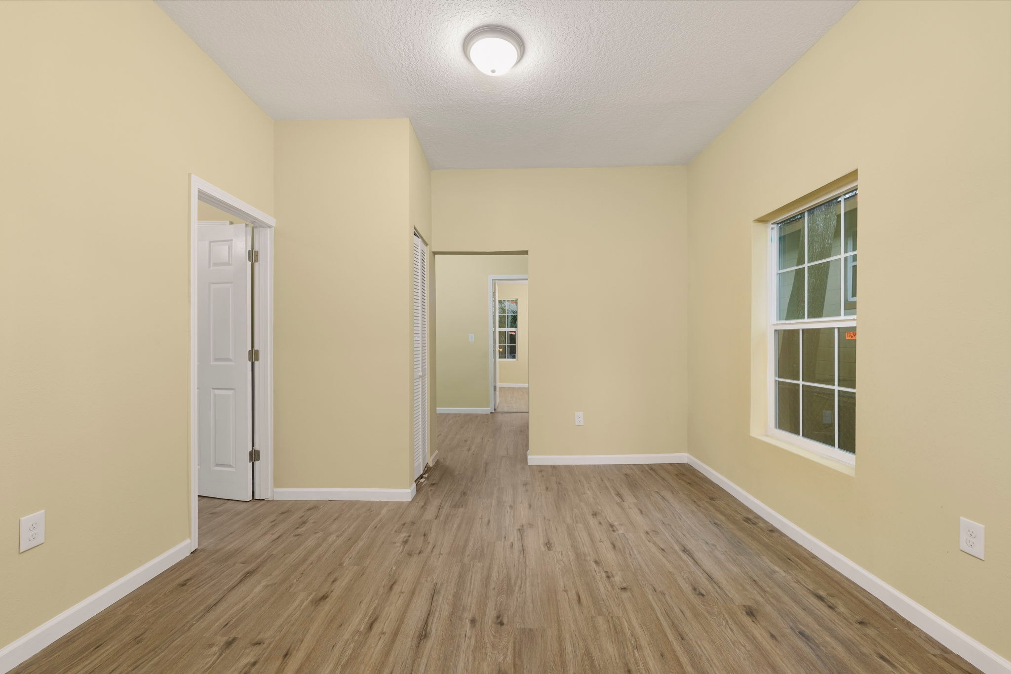Renovated room with natural light and hardwood floors