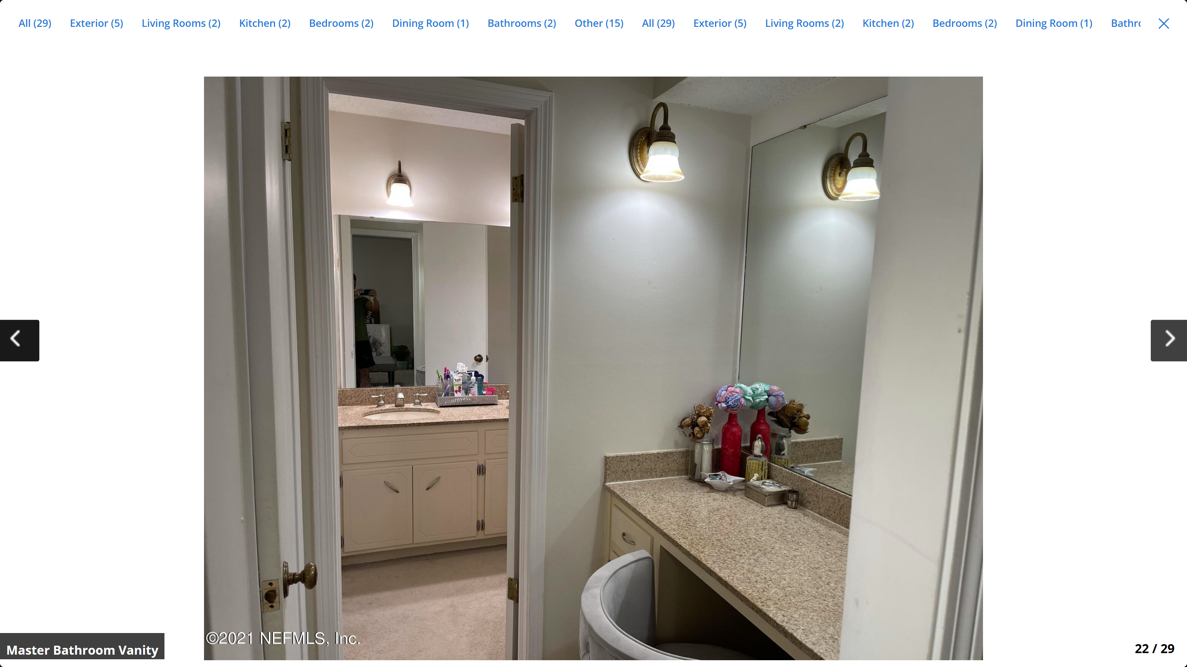 Master bathroom vanity – granite countertop, white cabinets, wall sconces and mirror