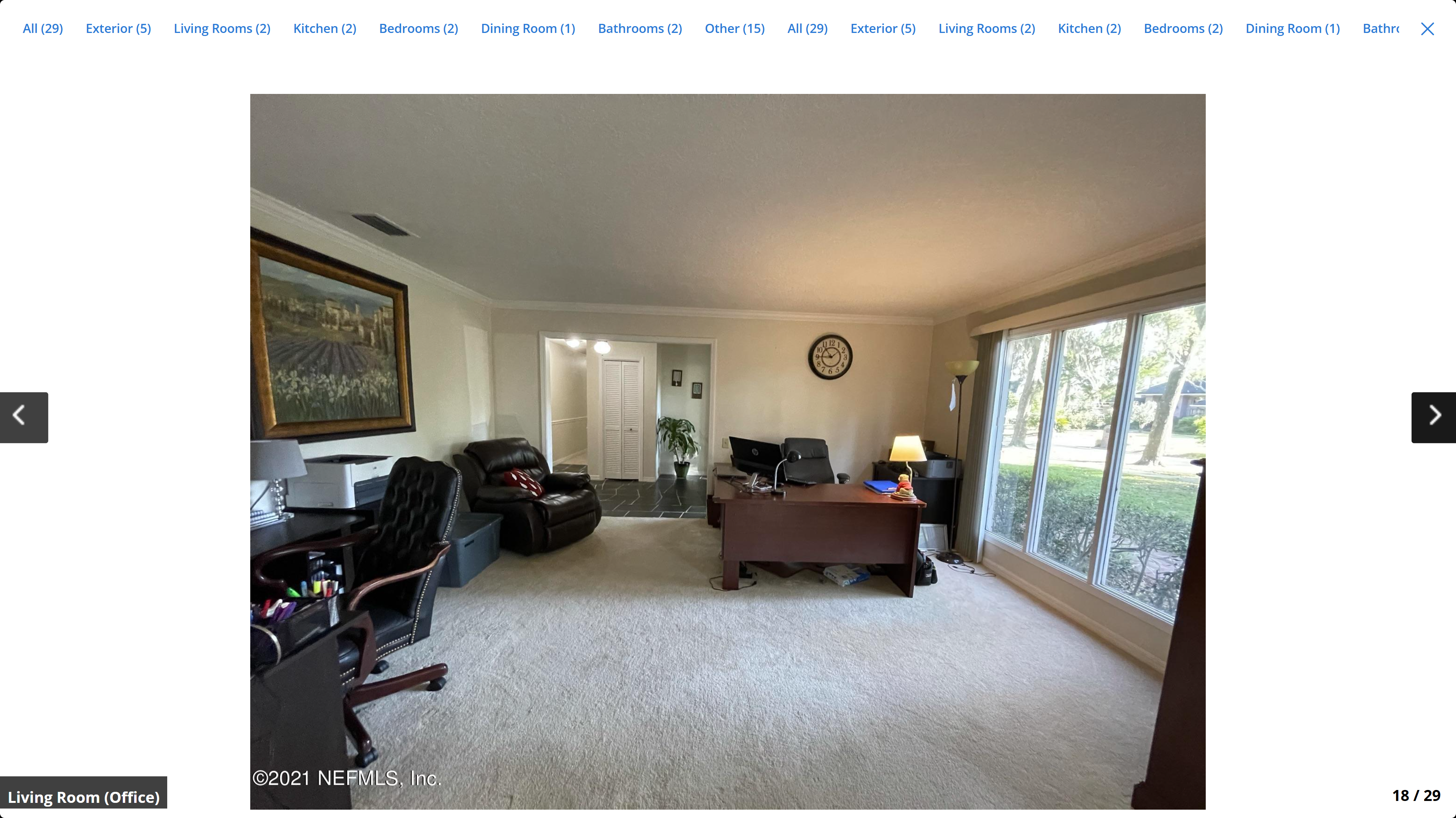 Spacious living room / office – crown molding, large sliding glass windows overlooking yard
