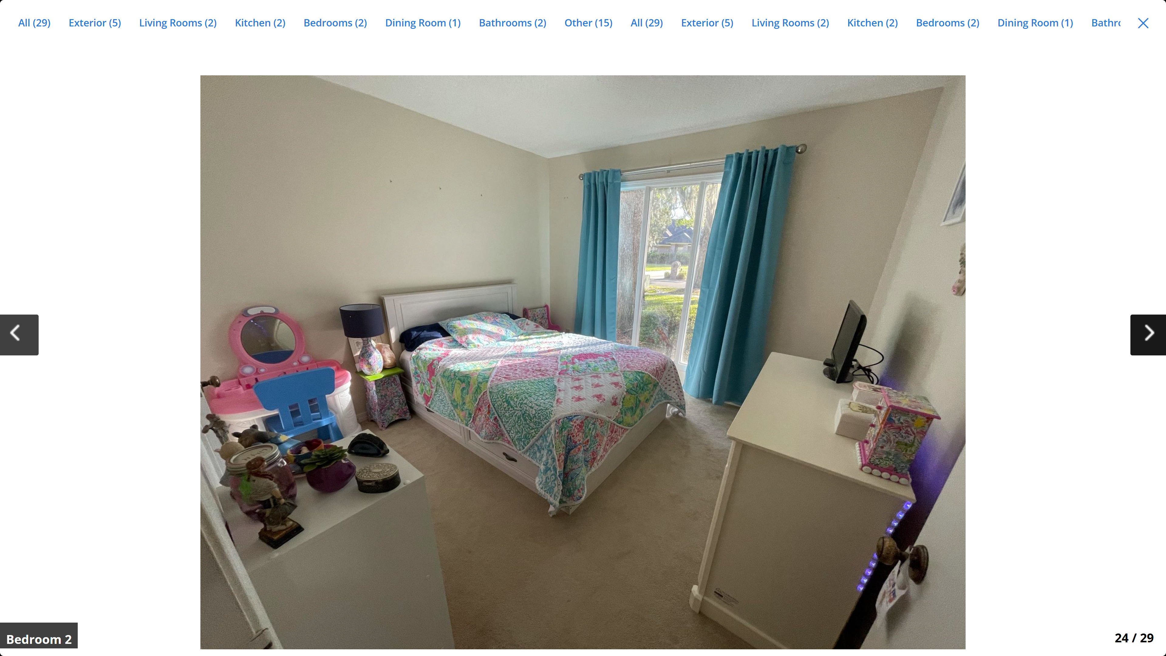 Bedroom 2 – carpet, large window with teal curtains, natural light
