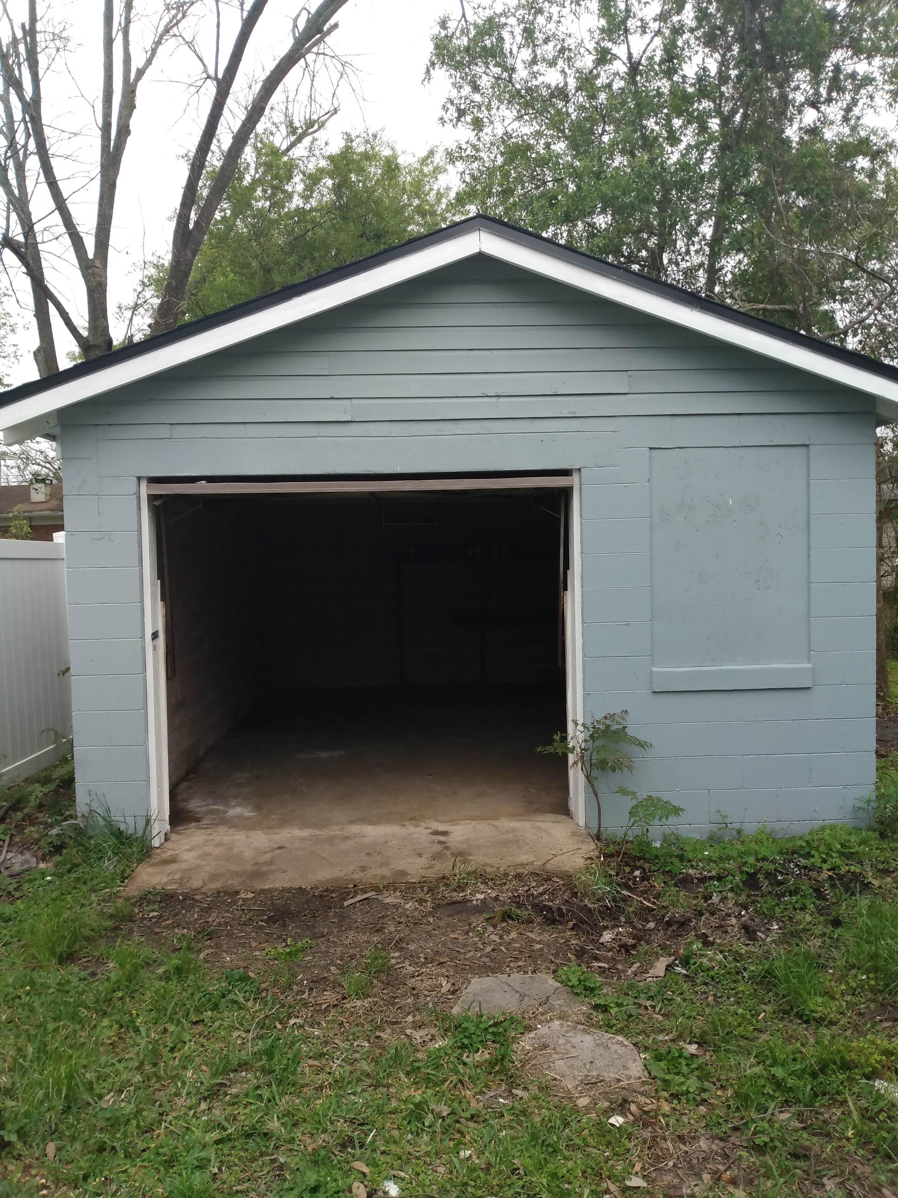 Detached garage – light blue block construction with open door