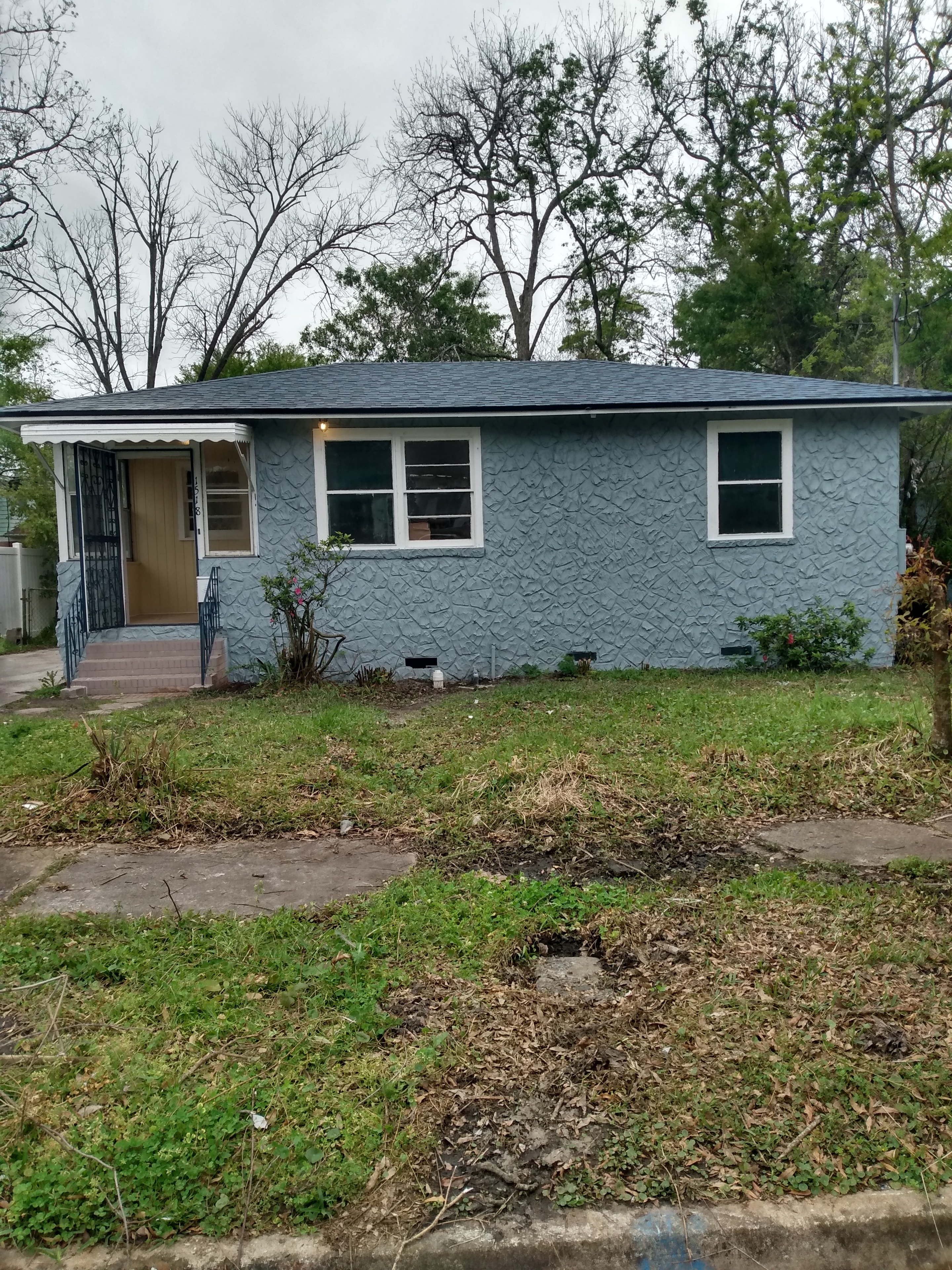1518 W 14th St – exterior front view, renovated blue stucco home